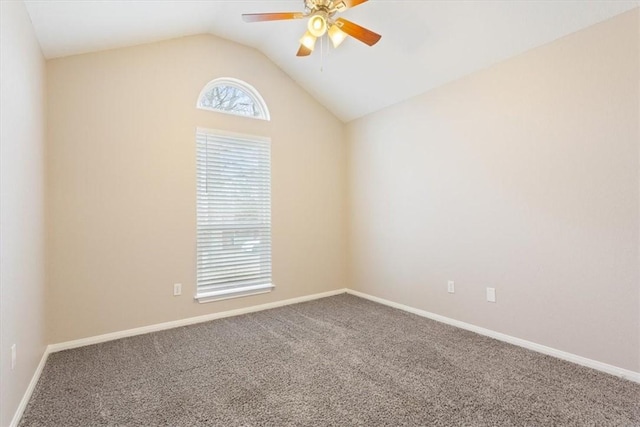 unfurnished room with carpet, baseboards, vaulted ceiling, and a ceiling fan