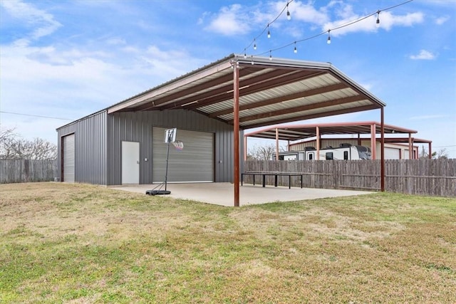 exterior space featuring an outbuilding and fence