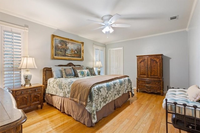 bedroom featuring crown molding, ceiling fan, and light wood-type flooring