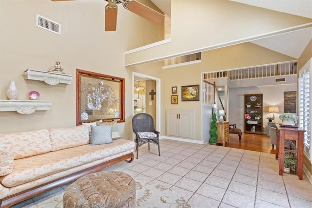 living room featuring ceiling fan, tile patterned flooring, and high vaulted ceiling