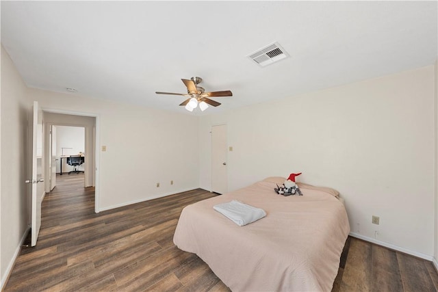 bedroom with dark hardwood / wood-style floors and ceiling fan