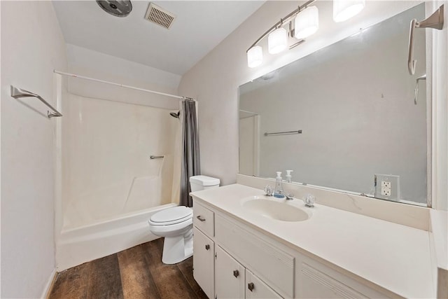 full bathroom with hardwood / wood-style floors, vanity, toilet, and shower / bath combo with shower curtain