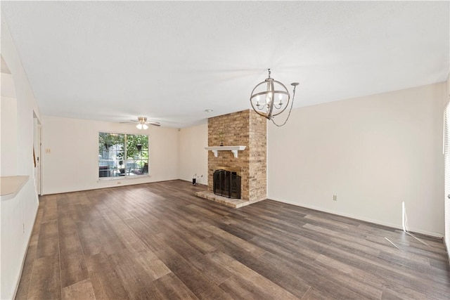 unfurnished living room featuring a fireplace, ceiling fan with notable chandelier, and hardwood / wood-style flooring