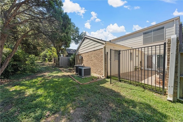 view of yard with central AC and a patio area