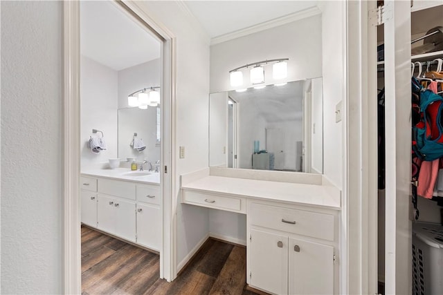 bathroom with hardwood / wood-style floors, vanity, and ornamental molding