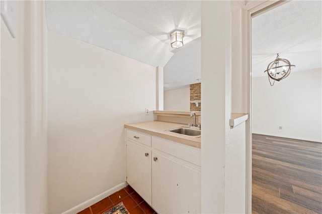 kitchen with white cabinetry, sink, and dark wood-type flooring