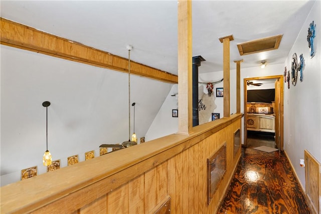 corridor featuring dark wood-type flooring and vaulted ceiling