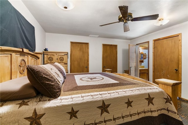 bedroom featuring ceiling fan and multiple closets