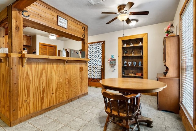 dining area with plenty of natural light, ceiling fan, and light tile patterned floors