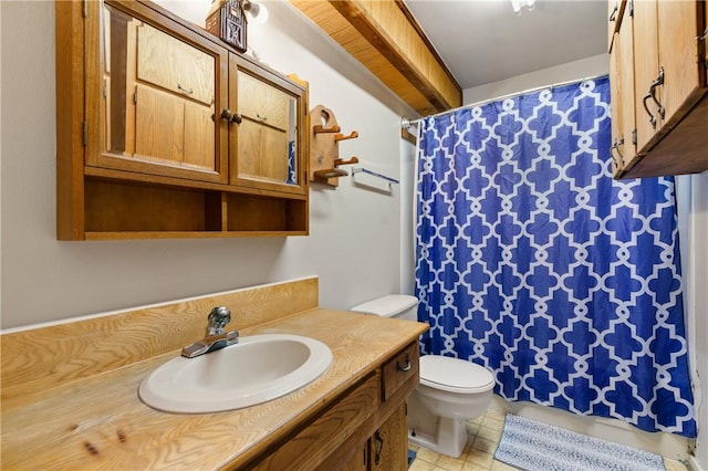 bathroom featuring tile patterned flooring, vanity, and toilet