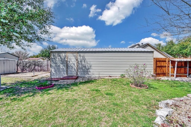 view of yard featuring an outdoor structure and a fenced backyard