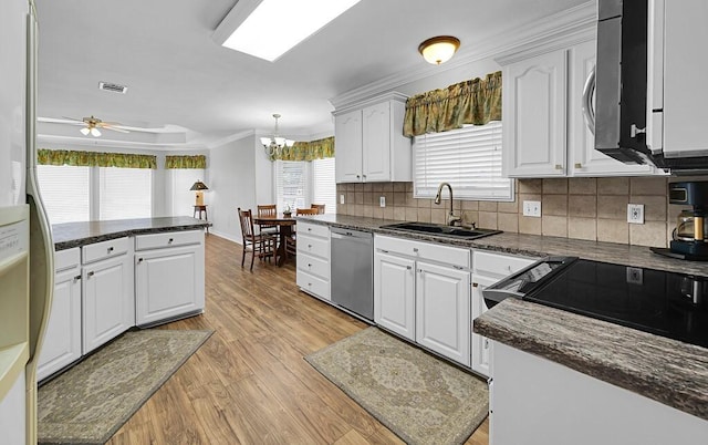 kitchen featuring a sink, light wood-style flooring, white cabinets, and stainless steel appliances