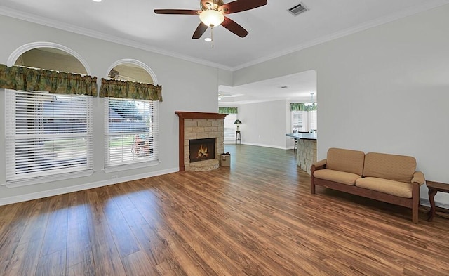 unfurnished living room with visible vents, ornamental molding, a ceiling fan, and wood finished floors