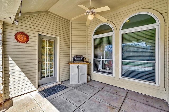 entrance to property with a ceiling fan