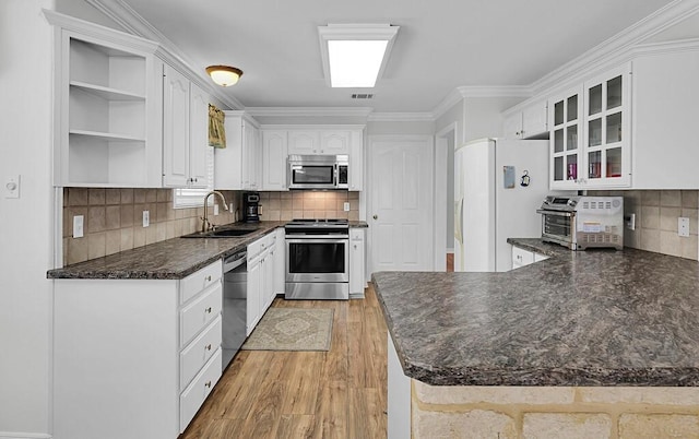 kitchen featuring open shelves, a toaster, a sink, stainless steel appliances, and dark countertops