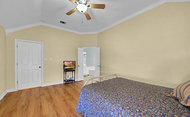 unfurnished bedroom with visible vents, wood finished floors, crown molding, baseboards, and vaulted ceiling