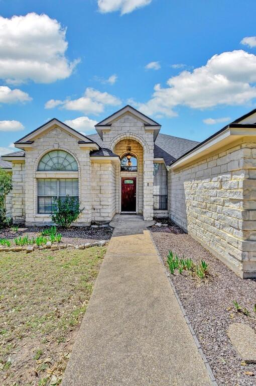 french country style house featuring stone siding and a shingled roof