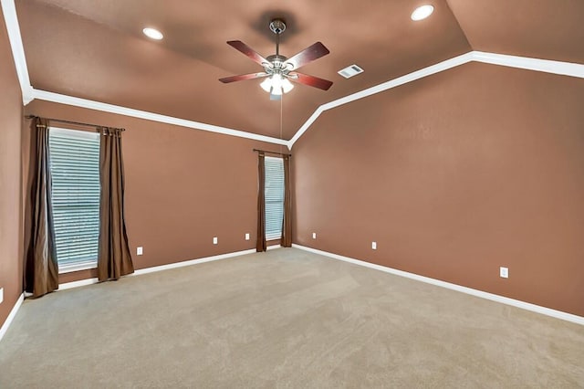 carpeted empty room with ceiling fan, lofted ceiling, and crown molding