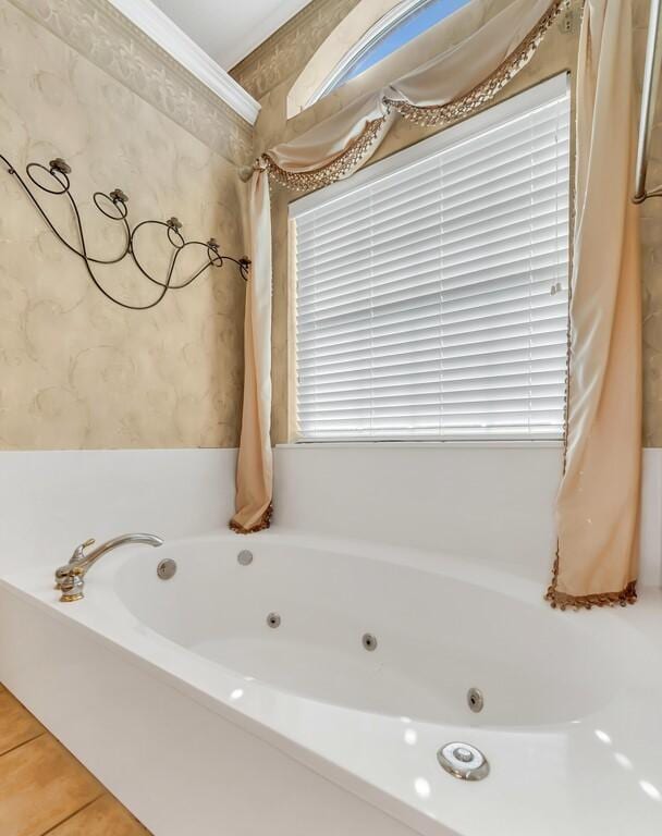 bathroom with tile patterned flooring and a bathtub