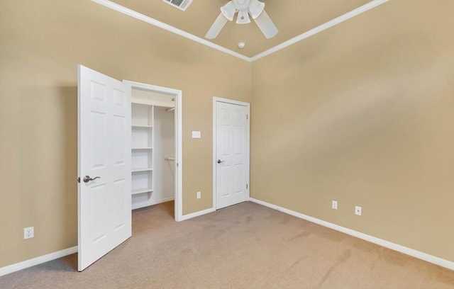 unfurnished bedroom featuring carpet, ceiling fan, and ornamental molding