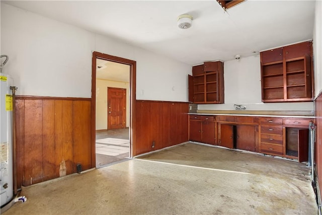 kitchen with water heater and wood walls