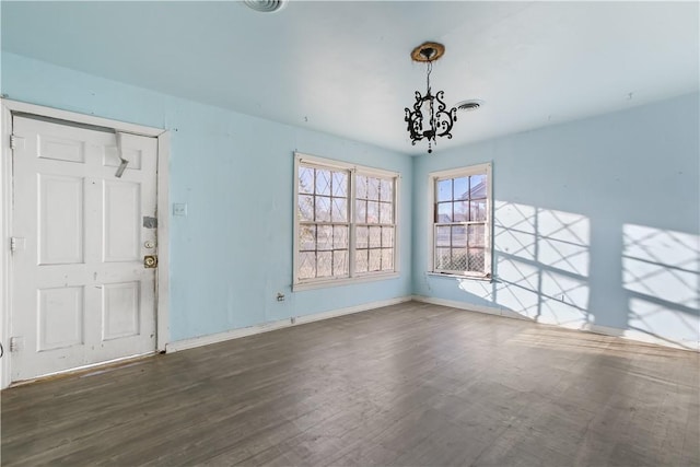 interior space featuring dark hardwood / wood-style flooring and a chandelier