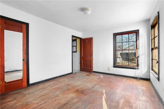 spare room with hardwood / wood-style floors