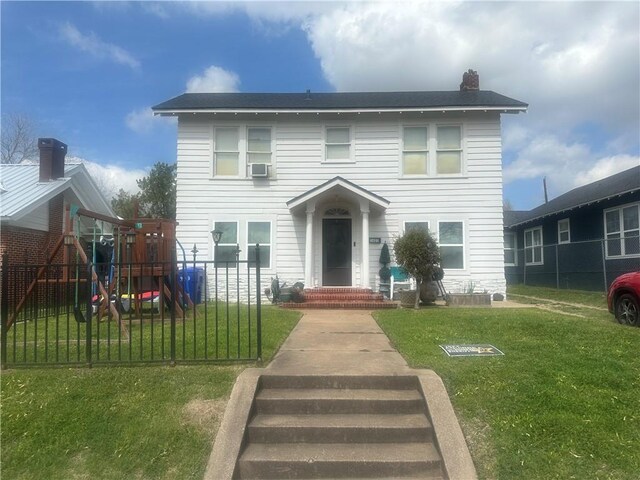 view of front facade featuring a playground and a front yard