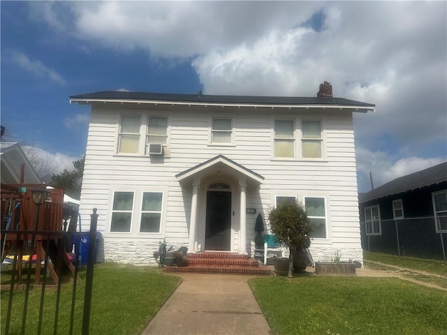 view of front of house featuring a playground and a front yard