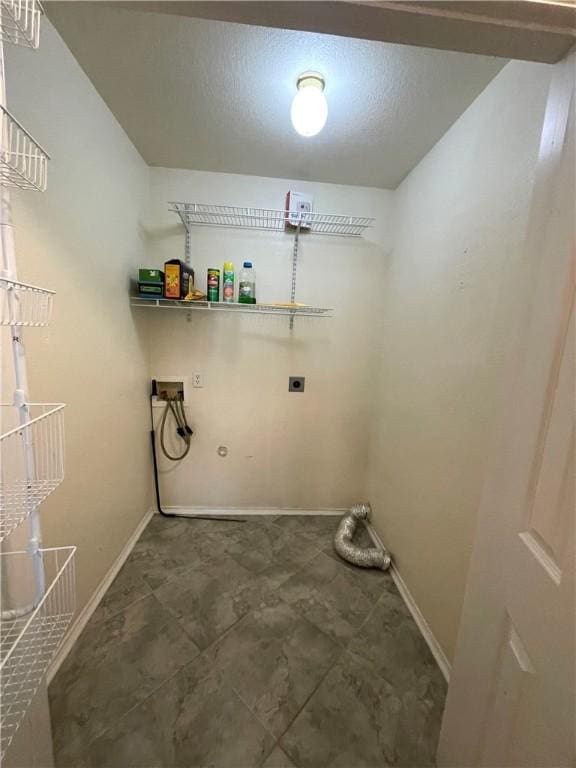 washroom with washer hookup, a textured ceiling, and hookup for an electric dryer