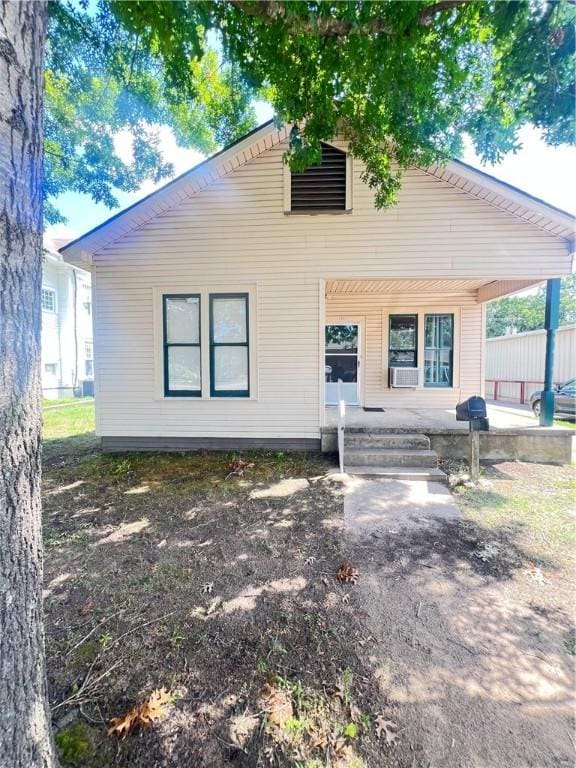 view of front facade with cooling unit and covered porch