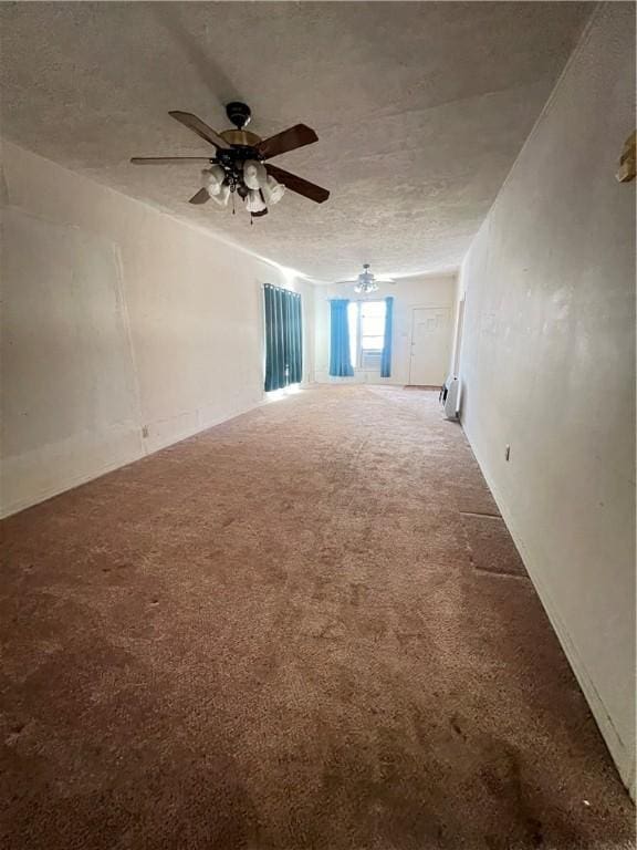 carpeted empty room with ceiling fan and a textured ceiling