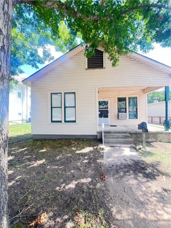 back of property featuring a porch