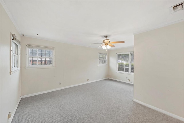 empty room featuring light carpet, plenty of natural light, and ceiling fan