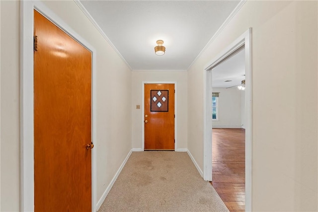 entryway featuring light wood-type flooring and ornamental molding