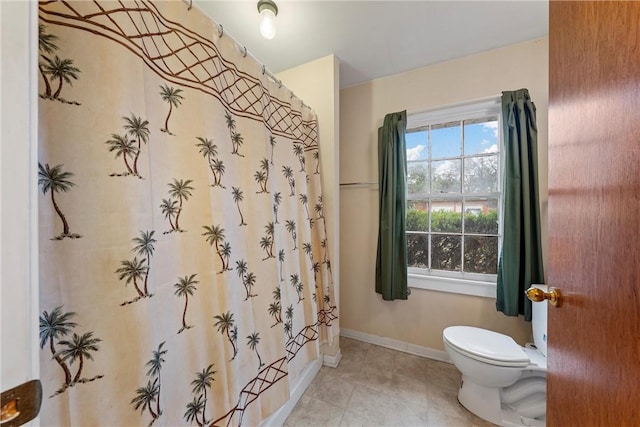 bathroom featuring tile patterned flooring, toilet, and shower / bathtub combination with curtain