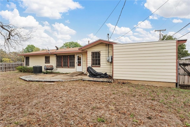 rear view of house featuring a patio area and cooling unit