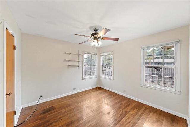 empty room with hardwood / wood-style flooring, plenty of natural light, and ceiling fan