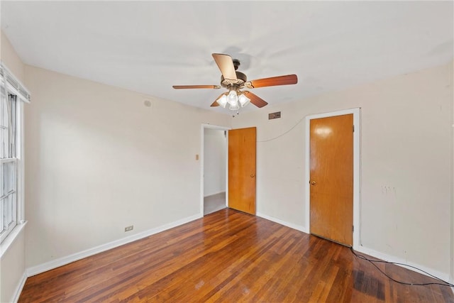 unfurnished room with ceiling fan and dark hardwood / wood-style floors