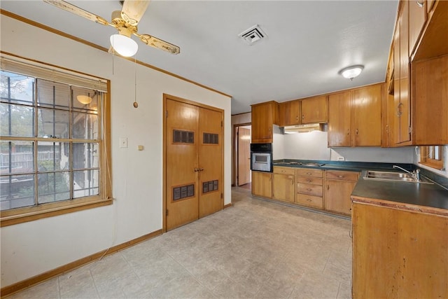 kitchen with gas cooktop, black oven, ceiling fan, and sink