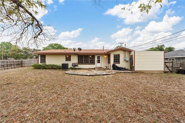 rear view of property with cooling unit and a patio