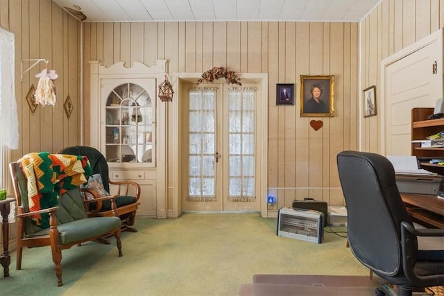 office featuring french doors, wooden walls, and carpet flooring