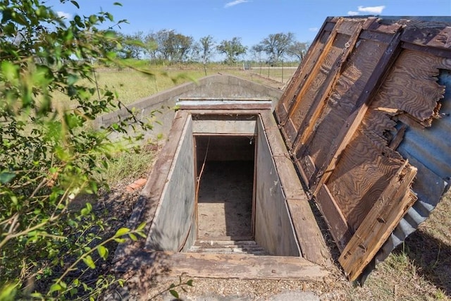 entry to storm shelter with a rural view