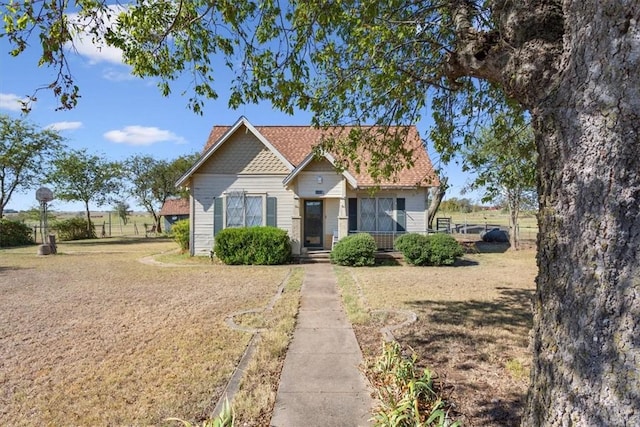 bungalow-style home with a front yard