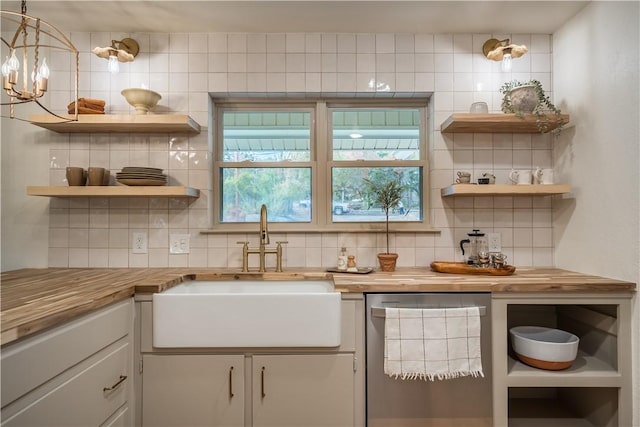 kitchen featuring decorative backsplash, wood counters, dishwasher, and sink