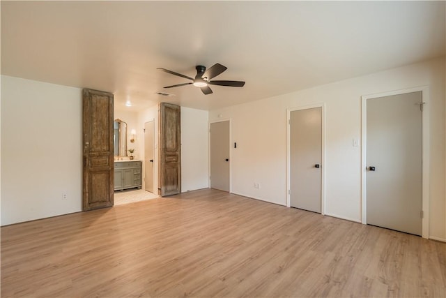 unfurnished bedroom featuring ceiling fan, light hardwood / wood-style floors, and ensuite bath