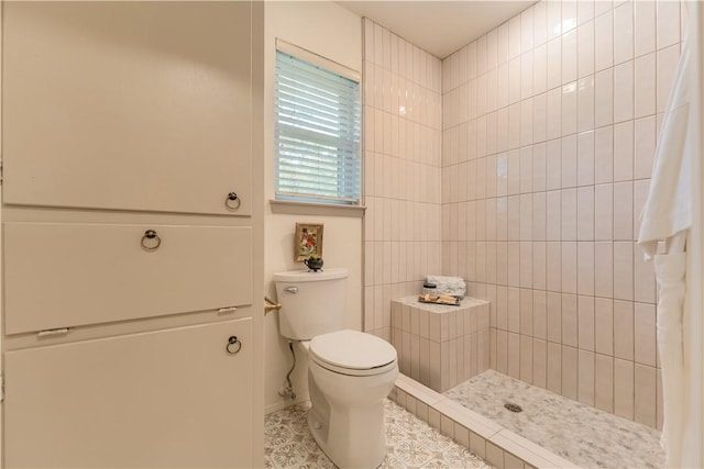 bathroom with tile patterned floors, toilet, and curtained shower