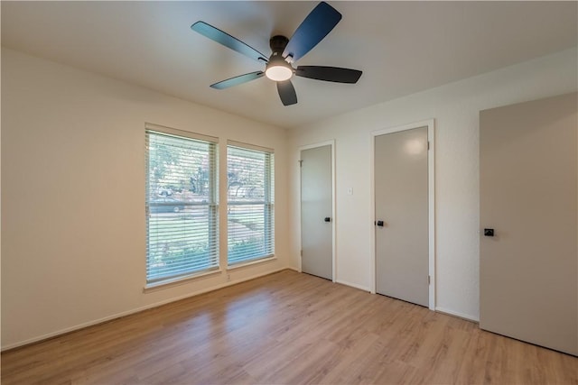 unfurnished bedroom with ceiling fan and light wood-type flooring