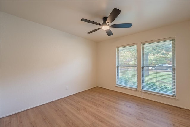 spare room featuring light hardwood / wood-style flooring and ceiling fan