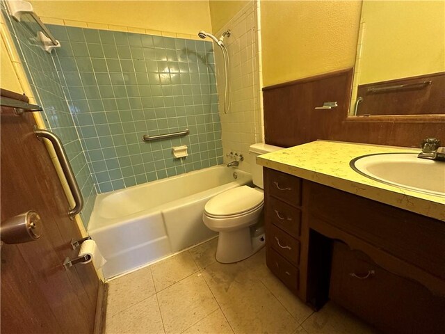 full bathroom featuring tile patterned floors, tiled shower / bath combo, toilet, and vanity